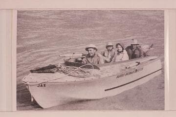 "JAX", the wizard hull owned by Jack Brennan and used on the Yampa and Green River in 1954. In the boat: Jack Brennan, Georgiana, Rena and Dr. Leslie White