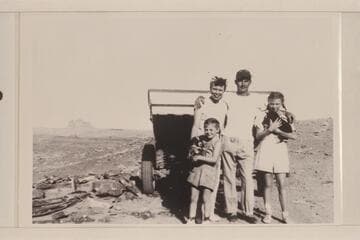 Doris, Norm, Joan and Sandra Nevills; Alhambra Rock and a Cataract boat in background.  Near Mexican Hat, Utah