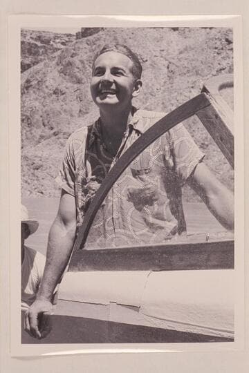 Jim Rigg posed for photo at head of Lake Mead at end of his first run with motor boats through Grand Canyon