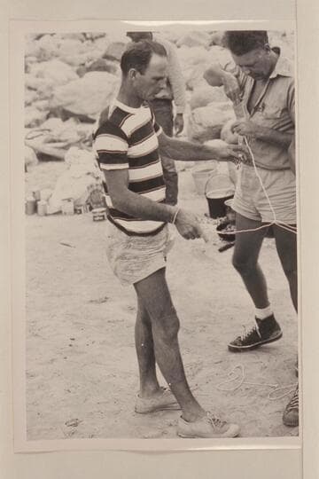 Norm Nevills working on puzzles at Diamond Creek in Grand Canyon during his 6th traverse. John Doerr at right