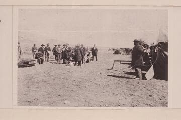 John D. Lee (left) sitting on his coffin at Mountain Meadows, Utah, awaiting execution by a firing squad