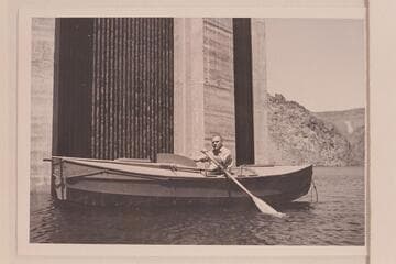 Buzz Holmstrom in his skiff, the "Julius F" after the end of the 1938 run from Wyoming to Lake Mead.  He was permitted to row down to the face of Hoover Dam for the publicity possibilities