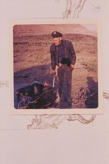 Jim Jordan stirs the fire at camp at the head of the Whitmore Trail