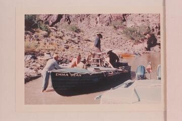 Preparing the "Emma Dean" for pictures at Bright Angel Creek. Herb Hirst is at left. Doc Hill is the far side of the boat. John Doerr is sitting in the fore cockpit. Larry Sanderson stands by the chair and Rod Sanderson is aft
