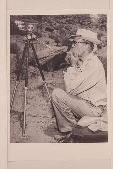 John Mull, photographer, seriously studies the passing scene