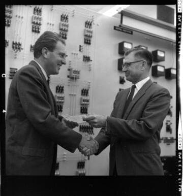 Men receiving Certificates of Completion for training at a substation with 21 variant