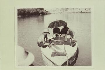 In Glen Canyon near Warm Creek. The boats were being towed by an outboard motor on the Wen. Nevills 1940 party. Del Reed sits at left