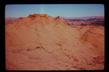 Opening in rocks on plateau southwest of Nasja Creek