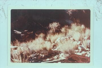 Ruins of Hance camp at Hance Asbestos Mine. Cast iron stove lower right