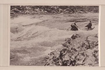 Canoe entering Grave Creek Falls in traverse of Rogue River by six UC students in 1954. "The canvas deck allows the high, curling waves to sweep across without swamping the canoe."