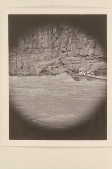 Brian Rowlands piloting the "Rattlesnake" through 217 Mile Rapid. Mert Ingham sits aft on the port side and John Schulz is next to him
