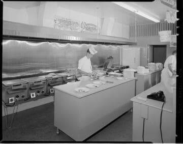 Chicken Delight take-out store with people preparing chicken dinners