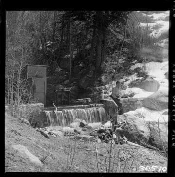 View along Tombstone Creek diversion dam. Gate is closed and all water is spilling over crest (note