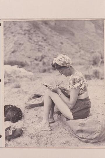 Becky Walker on Dolores River [on photo reverse: Mrs. Walker bringing diary up to date and dog "Detty."