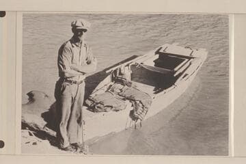 Merrill F. Spencer at Bright Angel Creek with his boat the "Ethel", after his run down from Lees Ferry in 1934, Oct