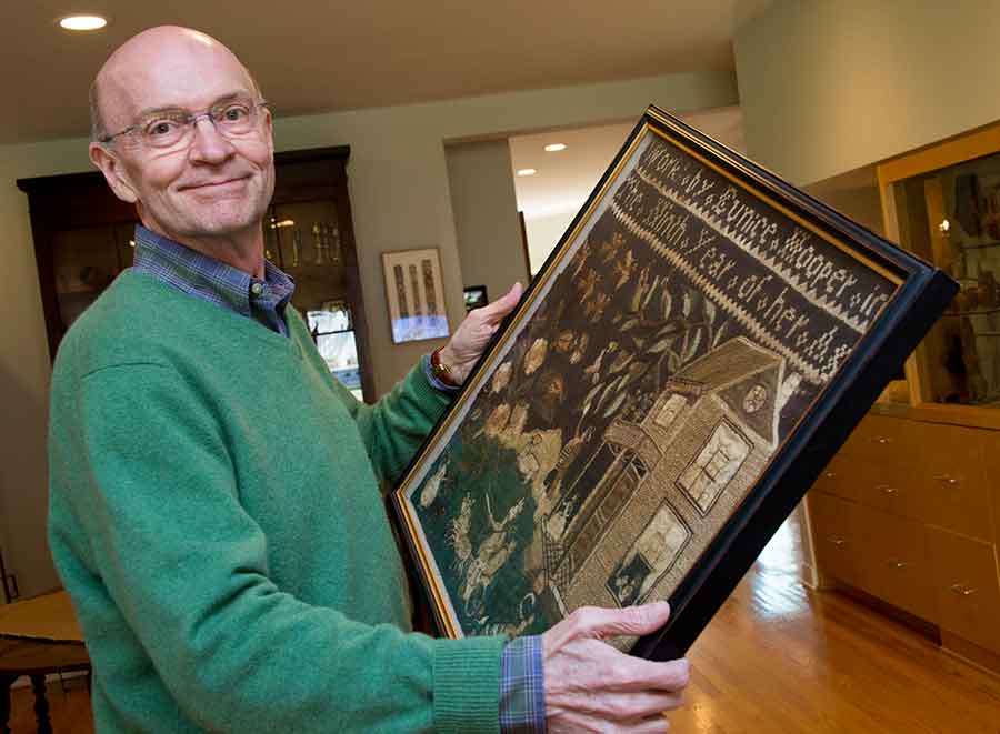 Harold B. Nelson, curator of American decorative arts at The Huntington, holding Eunice Hooper’s Sampler. Photograph by Kate Lain.