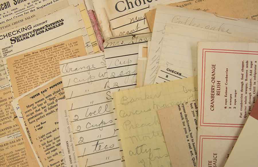 Close-up of manuscript and newspaper recipes mounted or laid in a charitable cookbook produced in Des Moines, Iowa, August 1903. Photograph by Kate Lain.