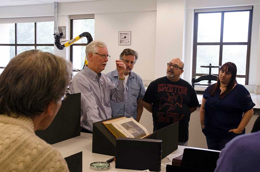 Stephen Tabor (far left), curator of early printed books at The Huntington, shows a Third Folio, 1663, of Shakespeare’s collected plays to teachers attending the Shakespeare at The Huntington institute program in July 2015. The annual program brings theater professionals together with teachers, who learn innovative techniques for teaching Shakespeare through performance. Photograph by Lisa Blackburn.