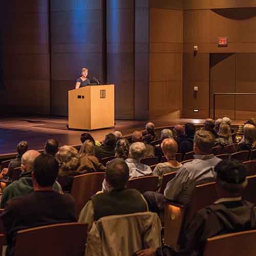 Speaker at podium with audience