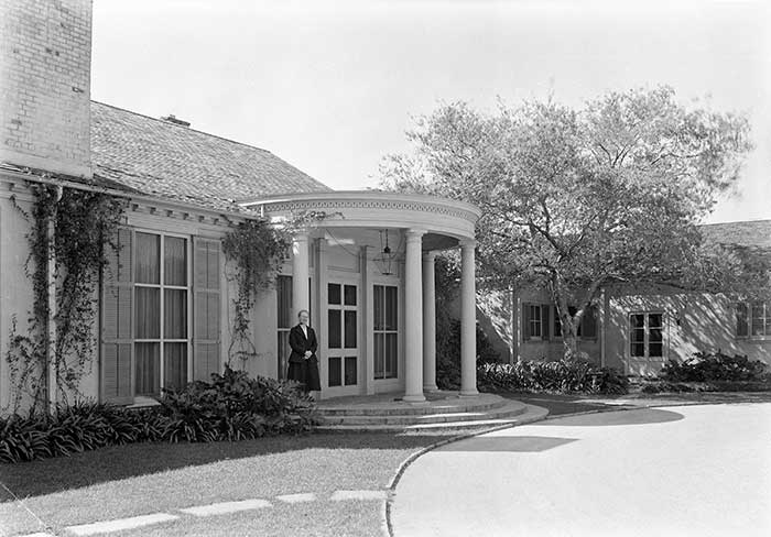 Beatrix Farrand, standing in front of the director’s house at The Huntington. She and her husband, the historian Max Farrand (1869–1945), who was the first director of The Huntington, lived in the house during all but the first three years of his tenure, which lasted from 1927 to 1941.