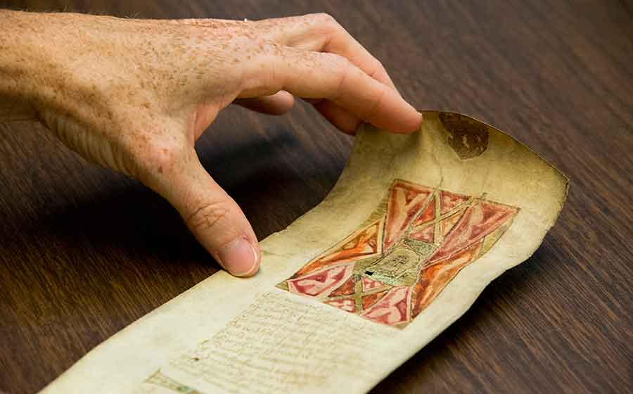 The Huntington Library’s manuscript of a 15th-century English poem written on a scroll of parchment approximately four inches wide and five feet long. The illustration and opening lines of the poem depict the Christological artifact known as Veronica’s veil. Christ’s face is just visible in the center of the image. Photograph by Kate Lain.