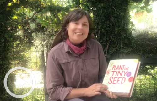 Staff member Cara with Plant the Tiny Seed book