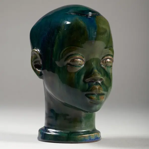  Glazed stoneware sculpture of a boy.