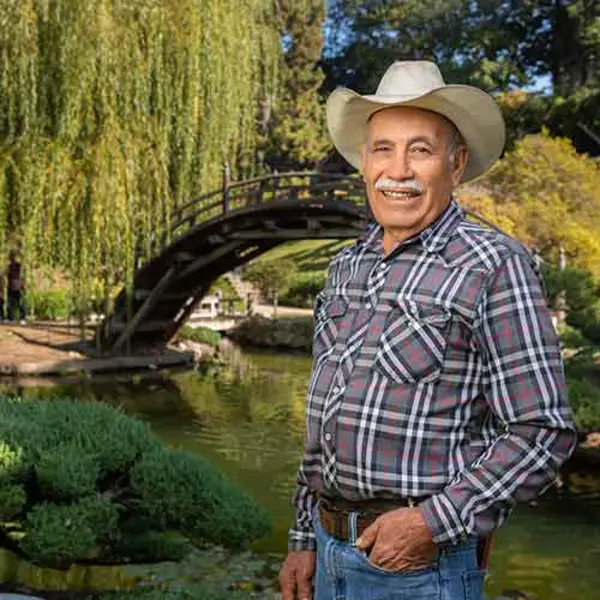 Ramiro Ramirez Pinedo, who has worked at The Huntington for 50 years, stands in his favorite place on the grounds, the Japanese Garden. Photo by Jamie Pham.