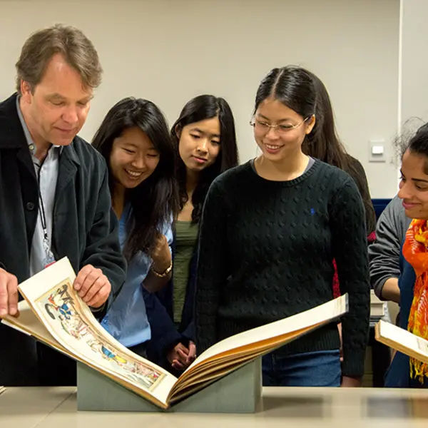 Caltech professor Kevin Gilmartin shows his English 127 students a book