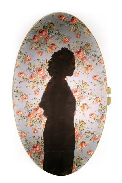 A side-profile silhouette of a person against a floral background.
