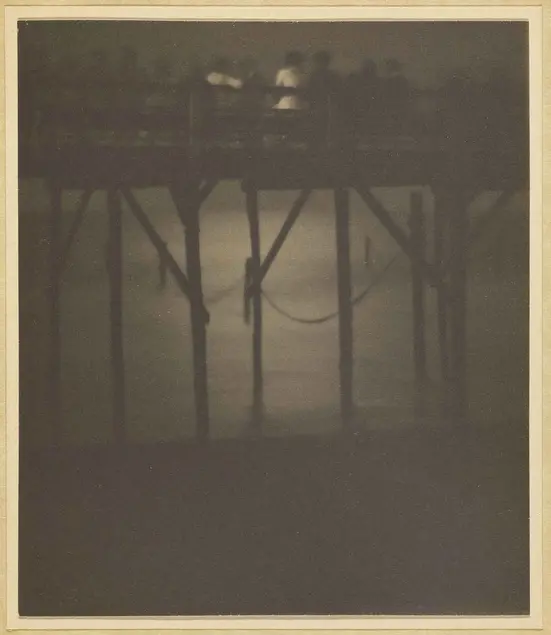Karl F. Struss, Crowded Pier by Moonlight, Arverne, Long Island, New York, 1910–1912, sepia toned platinum print, 4 1/4 × 3 5/8 in. The J. Paul Getty Museum, Los Angeles. © 1983 Amon Carter Museum of Art, Fort Worth, Texas.