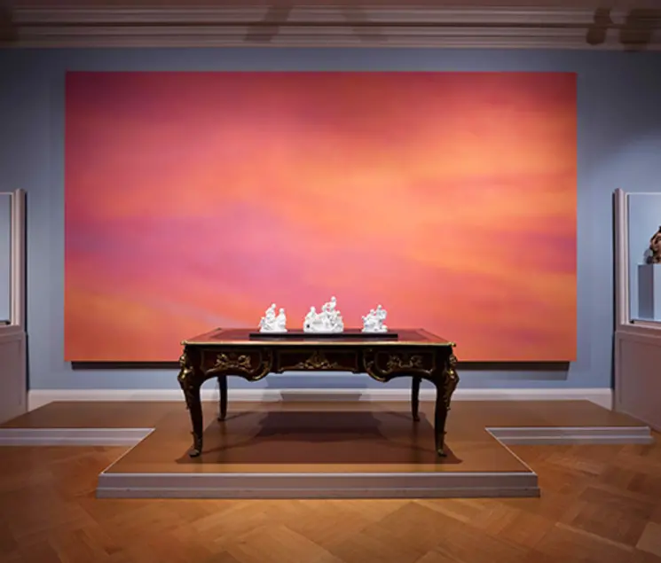 Alex Israel's Sky Backdrop, 2015, behind Sèvres biscuit porcelain figures atop an 18th-century French table