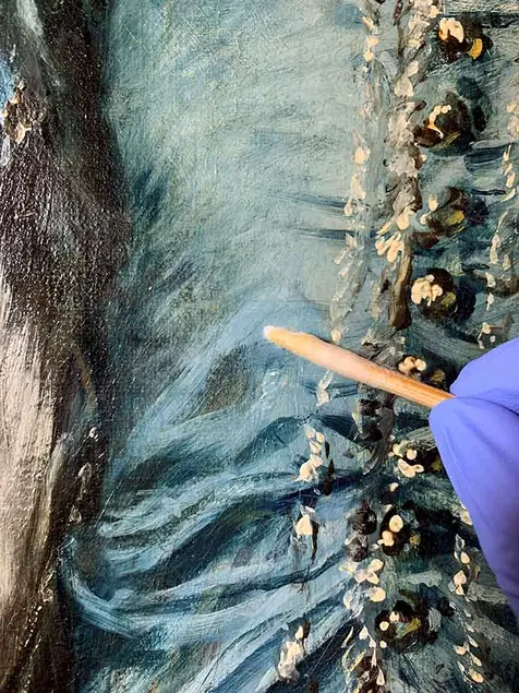 The conservator removed yellowed and cloudy varnish with small cotton swabs to reveal Gainsborough’s brilliant blues, visible in the lower portion of the photo. The Huntington Library, Art Museum, and Botanical Gardens.