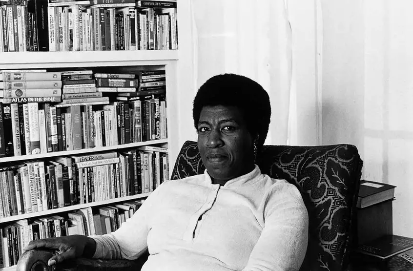  Patti Perret, photograph of Octavia E. Butler seated by her bookcase, 1984.  The Huntington Library, Art Museum, and Botanical Gardens. © Patti Perret 