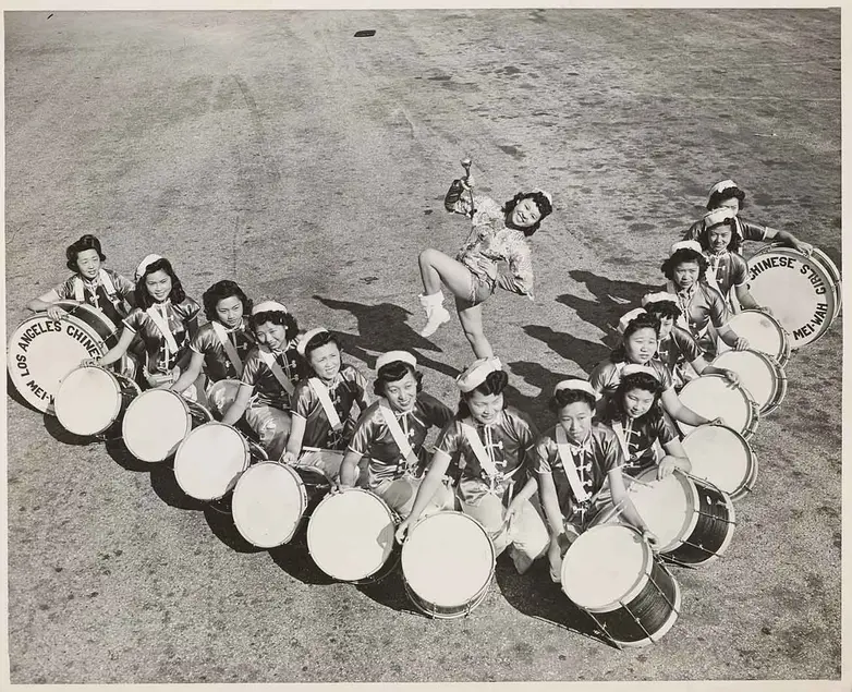Mei Wah Drum Corps led by Drum Majorette Barbara Jean Wong Lee, 1940. The Huntington Library, Art Museum, and Botanical Gardens.