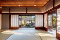 A formal reception room in a traditional Japanese house, with sliding doors open to a private garden.