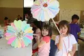 Explorers campers holding giant paper flowers