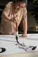 Calligrapher Tang Qingnian 唐慶年 at work on a large scroll during a public demonstration in 2018. Tang was the Cheng Family Foundation Artist-in-Residence at The Huntington in 2019. The Huntington Library, Art Museum, and Botanical Gardens. Photo by Jaime Pham