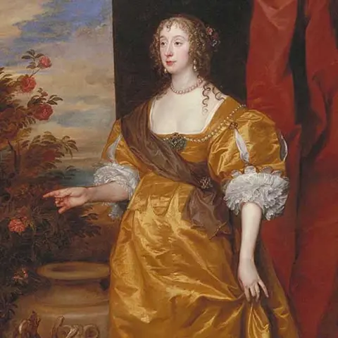 Lady wearing yellow gown pointing