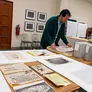 Rosten Woo inspecting archival materials