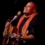 Portrait of Toshi Reagon playing guitar
