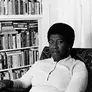  Patti Perret, photograph of Octavia E. Butler seated by her bookcase, 1984.  The Huntington Library, Art Museum, and Botanical Gardens. © Patti Perret
