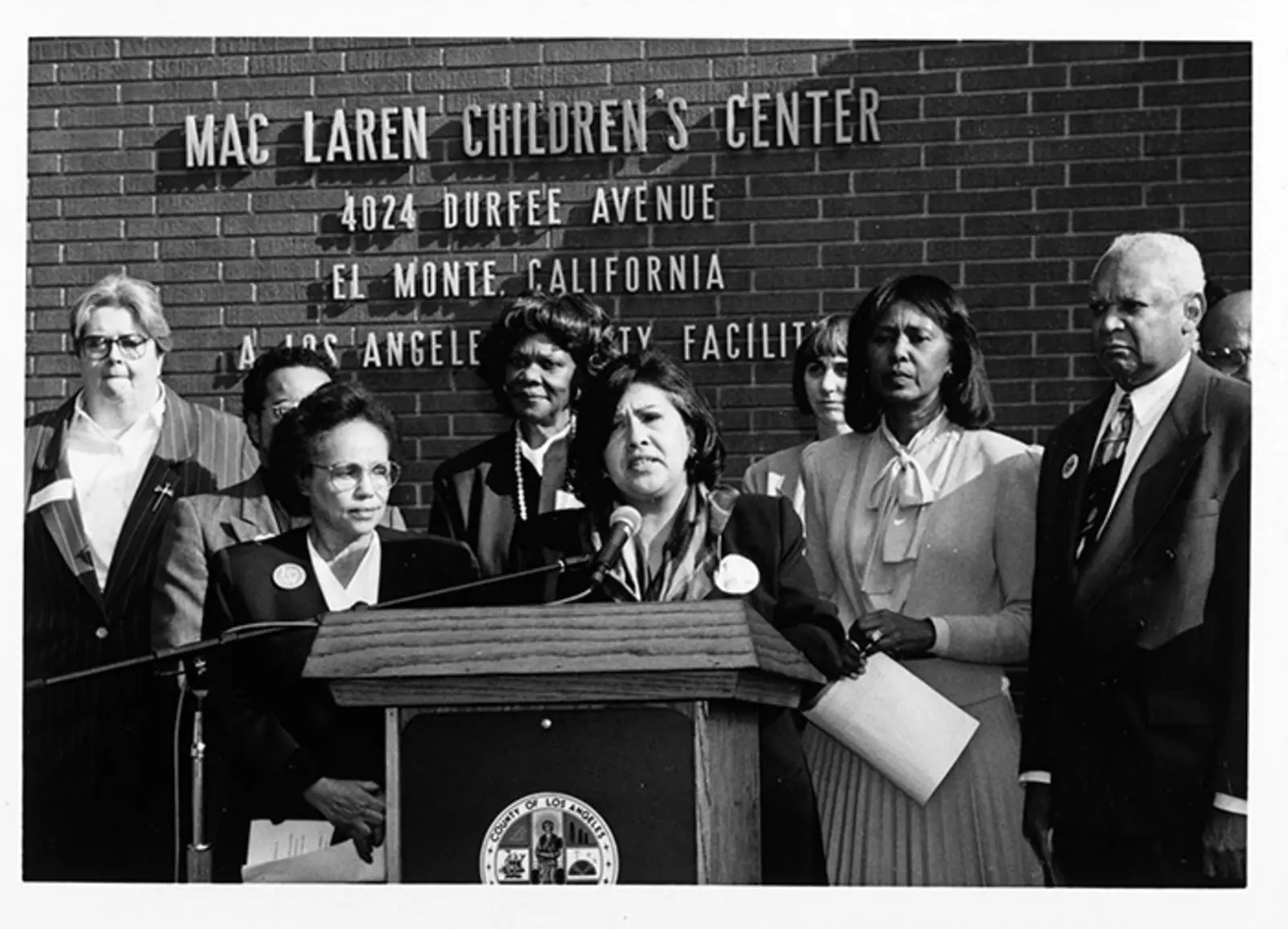 Gloria Molina at a podium outside the MacLaren Children’s Center