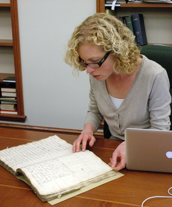 A researcher studies a manuscript in the Ahmanson Reading Room. A researcher studies a manuscript in the Ahmanson Reading Room.