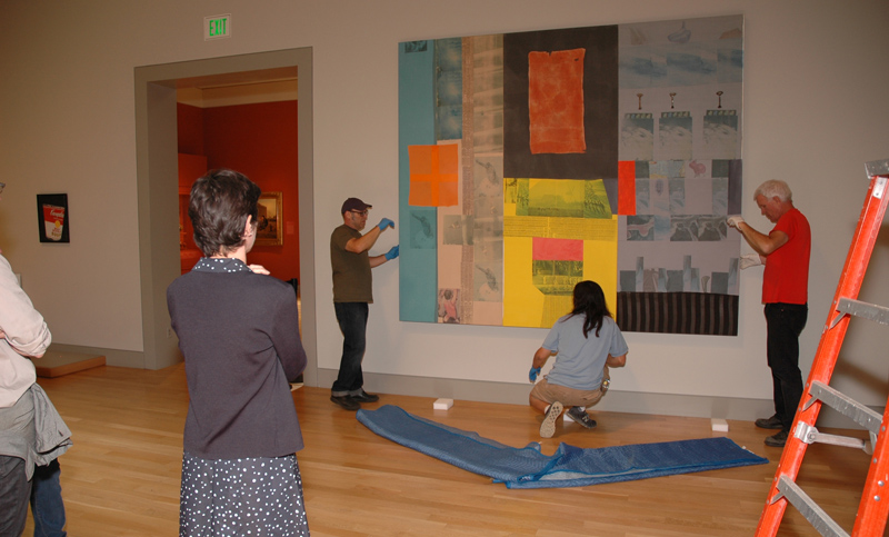 Curators watch as Global Loft (Spread) is secured in place by assistant preparator Curators watch as Global Loft (Spread) is secured in place by assistant preparator