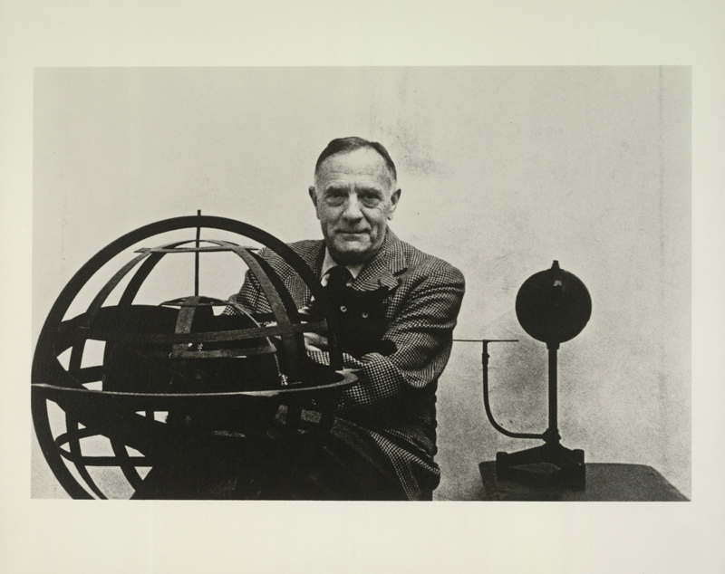Edwin Powell Hubble, seated with his cat Nicolas Copernicus, behind an armillary sphere and next to an orrery, March 1953. Huntington Library, Art Collections, and Botanical Gardens. Edwin Powell Hubble, seated with his cat Nicolas Copernicus, behind an armillary sphere and next to an orrery, March 1953. Huntington Library, Art Collections, and Botanical Gardens.
