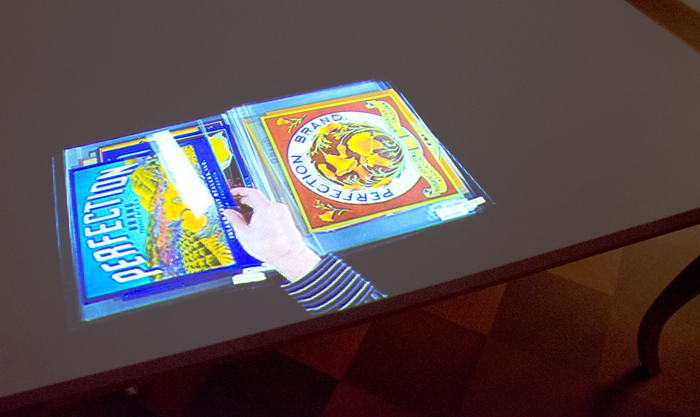 One of the 80 activities depicted in the 65-minute video: an archivist leafing through a set of orange crate labels from the Jay T. Last Collection.