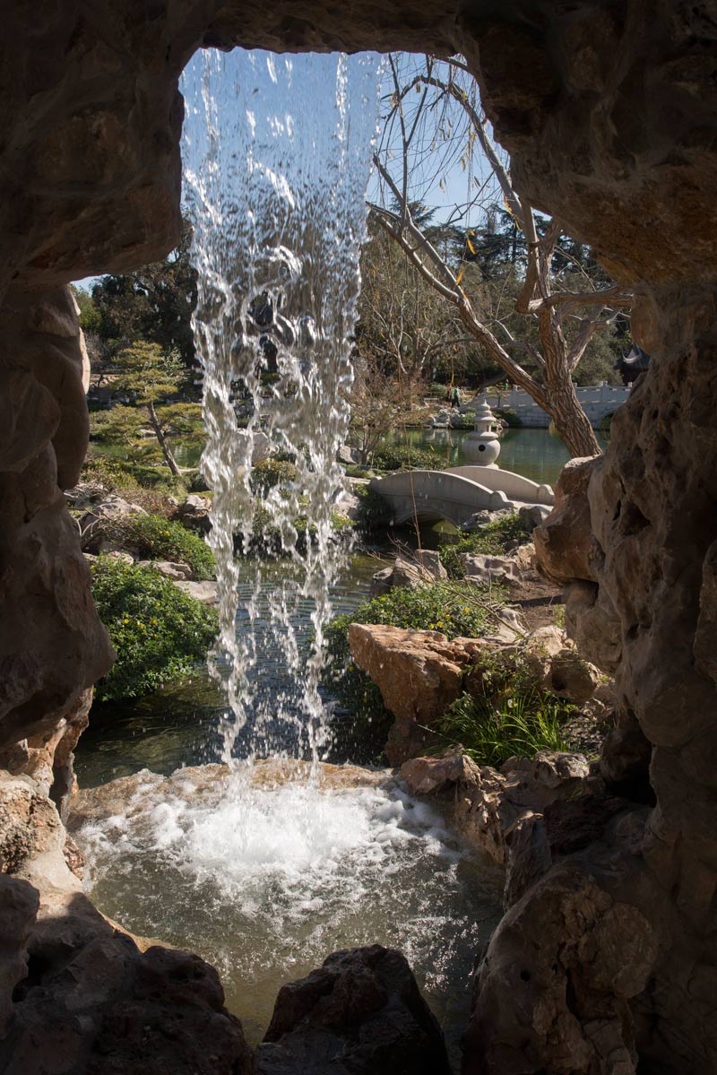 View from behind the waterfall in the Lingering Clouds Peak rock grotto