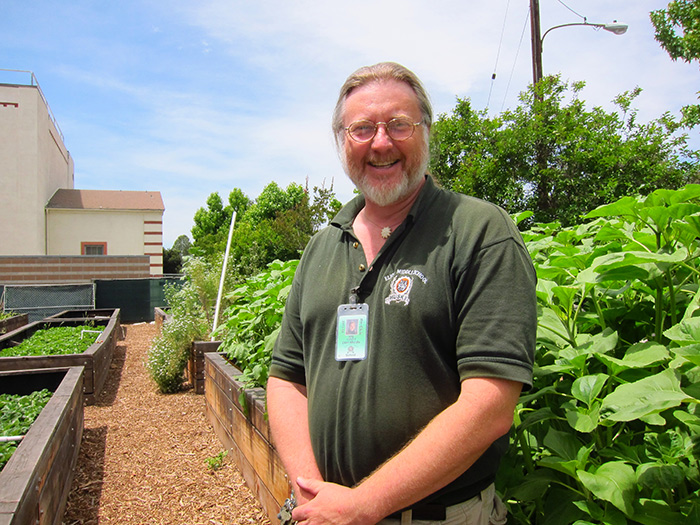 Eliot science teacher Roger Gray in the school’s garden. Photo by Linda Chiavaroli.