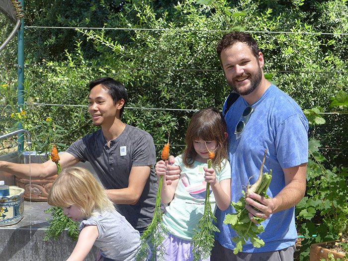 Visitors sample freshly picked carrots (and get a taste for the delights of home gardening) during a recent open house on the Ranch. Photos by Letizia Ragusa.